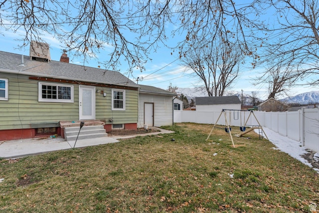 314 Harvard Cir, American Fork, UT 84003 - rear view of house with a mountain view, a fenced backyard, a chimney, a lawn, and a playground