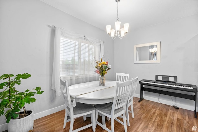 7465 N Cottage Ln, Eagle Mountain, UT 84005 - dining space featuring an inviting chandelier, baseboards, and wood finished floors