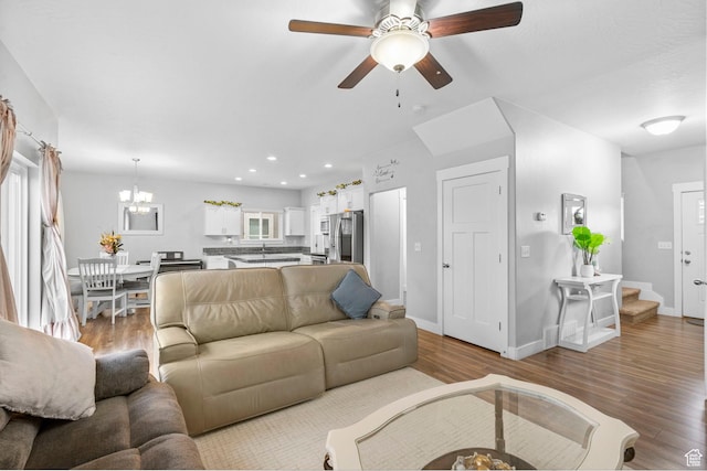 7465 N Cottage Ln, Eagle Mountain, UT 84005 - living room featuring recessed lighting, baseboards, wood finished floors, and ceiling fan with notable chandelier