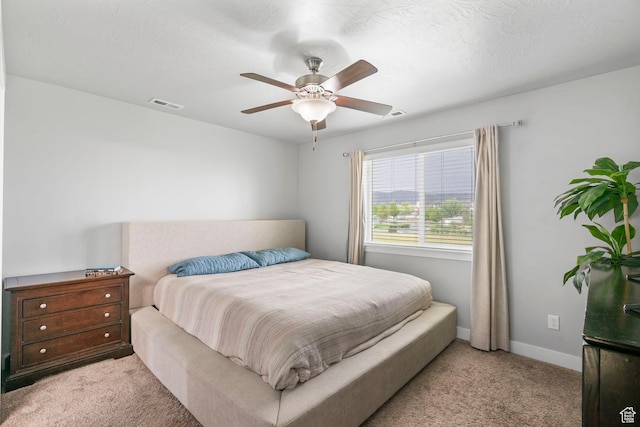 7465 N Cottage Ln, Eagle Mountain, UT 84005 - bedroom featuring light colored carpet, baseboards, visible vents, and a ceiling fan