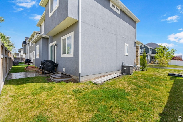 7465 N Cottage Ln, Eagle Mountain, UT 84005 - view of side of home featuring fence, a lawn, stucco siding, and cooling unit