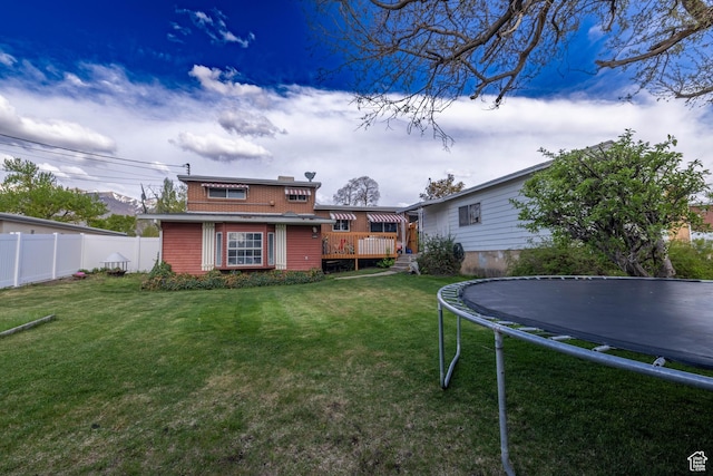 5393 S 700 E, South Ogden, UT 84405 - rear view of property with a lawn, a deck, fence, and a trampoline
