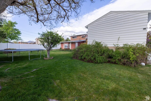 5393 S 700 E, South Ogden, UT 84405 - view of yard featuring a trampoline and fence
