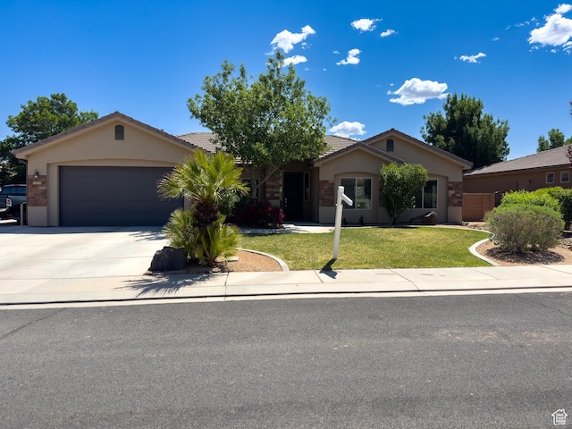 430 N 3450 W, Hurricane, UT 84737 - ranch-style home with stucco siding, a front yard, concrete driveway, a garage, and a tiled roof