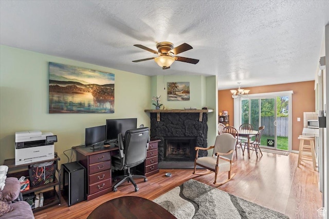 1554 S Monroe Blvd Unit F4, Ogden, UT 84404 - home office with a textured ceiling, wood finished floors, ceiling fan with notable chandelier, and a fireplace