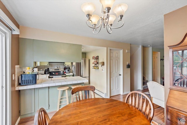 1554 S Monroe Blvd Unit F4, Ogden, UT 84404 - dining area with an inviting chandelier, baseboards, light wood-type flooring, and stairs