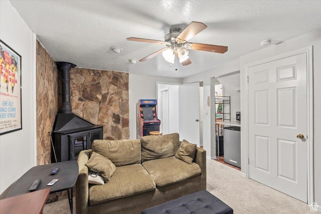 1554 S Monroe Blvd Unit F4, Ogden, UT 84404 - carpeted living room featuring a wood stove, a ceiling fan, and a textured ceiling