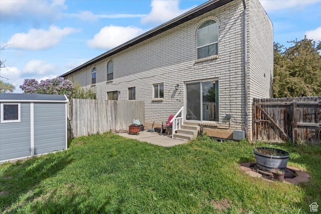 1554 S Monroe Blvd Unit F4, Ogden, UT 84404 - back of house featuring an outbuilding, a fenced backyard, a yard, and entry steps