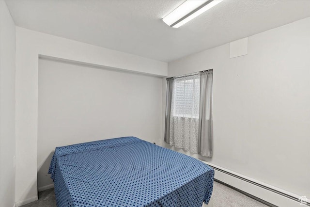 1554 S Monroe Blvd Unit F4, Ogden, UT 84404 - bedroom featuring carpet floors, baseboards, and a baseboard heating unit