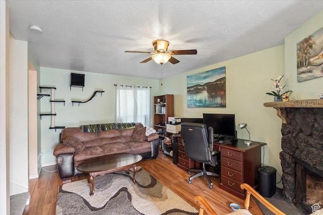 1554 S Monroe Blvd Unit F4, Ogden, UT 84404 - home office featuring a stone fireplace, a ceiling fan, and wood finished floors