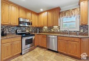5511 S 4170 W, Salt Lake City, UT 84118 - kitchen with stainless steel appliances, decorative backsplash, recessed lighting, a sink, and light stone finish floors