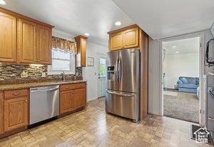 5511 S 4170 W, Salt Lake City, UT 84118 - kitchen featuring stainless steel appliances, recessed lighting, decorative backsplash, brown cabinets, and a sink