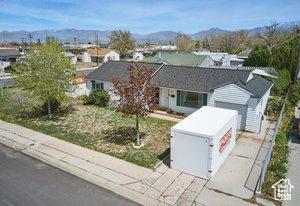 5511 S 4170 W, Salt Lake City, UT 84118 - single story home with concrete driveway, a garage, and a mountain view