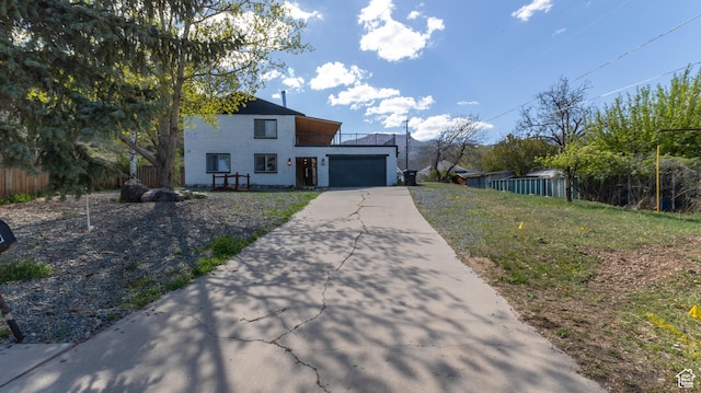 450 Hillside Pl, Cedar City, UT 84721 - view of front of home featuring fence, an attached garage, driveway, and brick siding