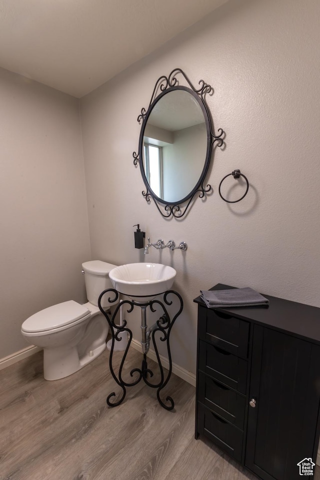 450 Hillside Pl, Cedar City, UT 84721 - half bathroom with a sink, baseboards, toilet, and wood finished floors