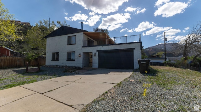 450 Hillside Pl, Cedar City, UT 84721 - contemporary house with fence, an attached garage, driveway, and a balcony