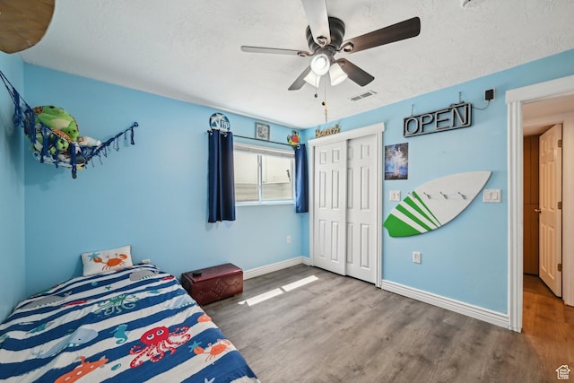8551 S Laurel Oak Dr W, West Jordan, UT 84081 - bedroom with a closet, visible vents, wood finished floors, baseboards, and a textured ceiling