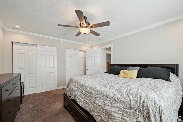 8551 S Laurel Oak Dr W, West Jordan, UT 84081 - bedroom featuring two closets, a textured ceiling, crown molding, and dark colored carpet