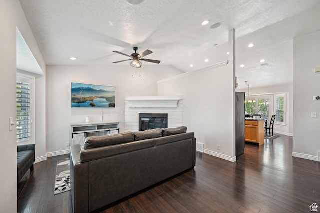 8551 S Laurel Oak Dr W, West Jordan, UT 84081 - living room with ceiling fan, a glass covered fireplace, baseboards, lofted ceiling, and visible vents