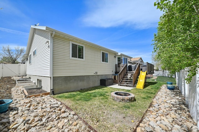 8551 S Laurel Oak Dr W, West Jordan, UT 84081 - back of house featuring a wooden deck, a fenced backyard, stairs, and an outdoor fire pit