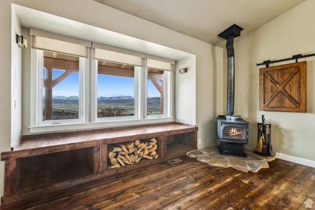 1586 Splendor Valley Rd, Kamas, UT 84036 - detailed view of wood finished floors, a wood stove, and baseboards