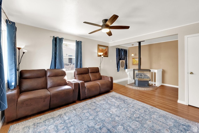 5756 S 4540 W, Kearns, UT 84118 - living area with baseboards, a ceiling fan, wood finished floors, and a wood stove