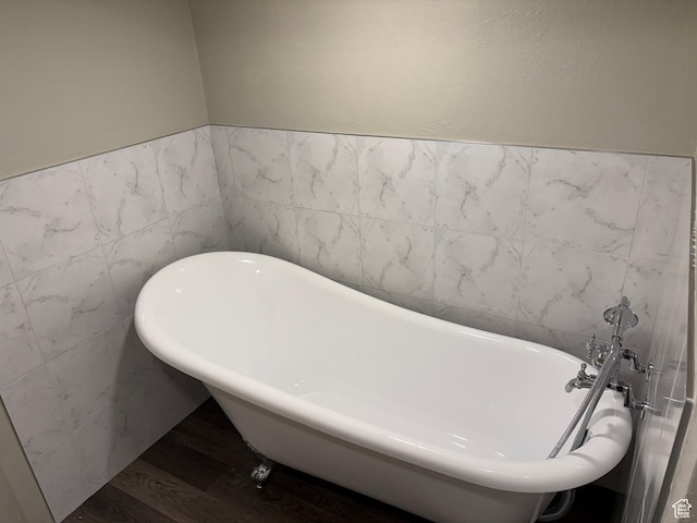 5756 S 4540 W, Kearns, UT 84118 - full bathroom with wood finished floors, a soaking tub, tile walls, and a wainscoted wall