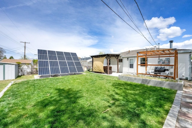 5756 S 4540 W, Kearns, UT 84118 - rear view of house featuring an outbuilding, a yard, a pergola, and solar panels
