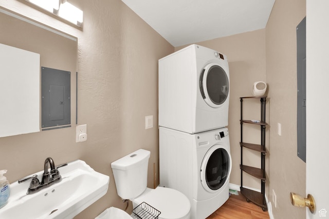 5756 S 4540 W, Kearns, UT 84118 - half bath with a sink, toilet, stacked washing maching and dryer, wood finished floors, and electric panel