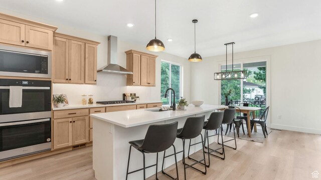 2298 E Parkside Cir S, South Ogden, UT 84403 - kitchen with light brown cabinetry, a sink, double oven, wall chimney exhaust hood, and stainless steel microwave
