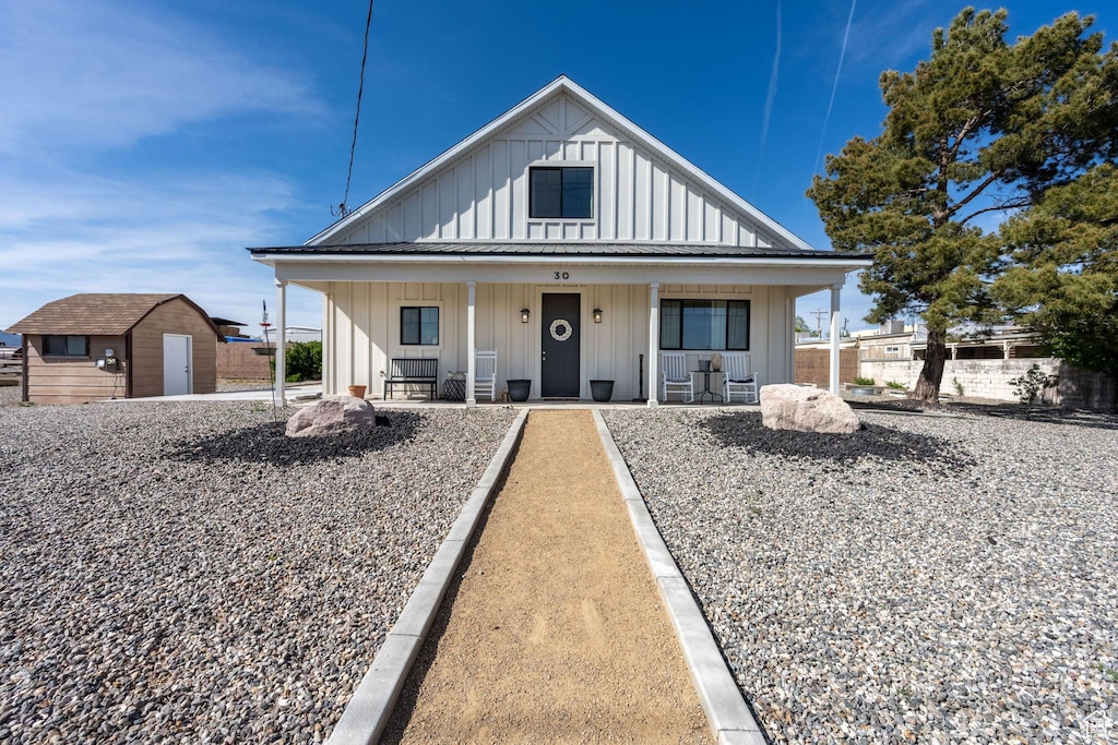 30 W Center St, Veyo, UT 84782 - bungalow-style house with a storage shed, an outbuilding, board and batten siding, and a porch