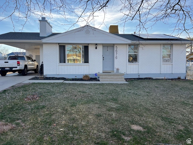 5676 S Wilderland Ln, Taylorsville, UT 84129 - view of front facade with a chimney, a front lawn, and brick siding