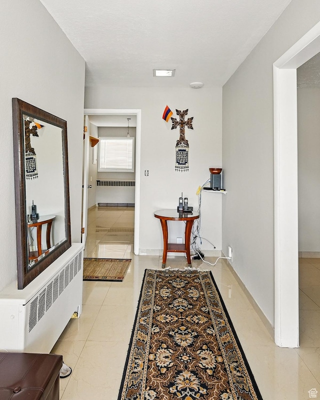 63 E Main, Bicknell, UT 84715 - corridor featuring baseboards and radiator heating unit
