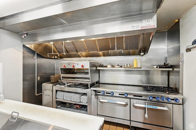 63 E Main, Bicknell, UT 84715 - kitchen featuring tile patterned flooring, wall chimney exhaust hood, and range with two ovens