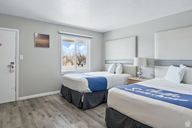 63 E Main, Bicknell, UT 84715 - bedroom with baseboards and wood finished floors