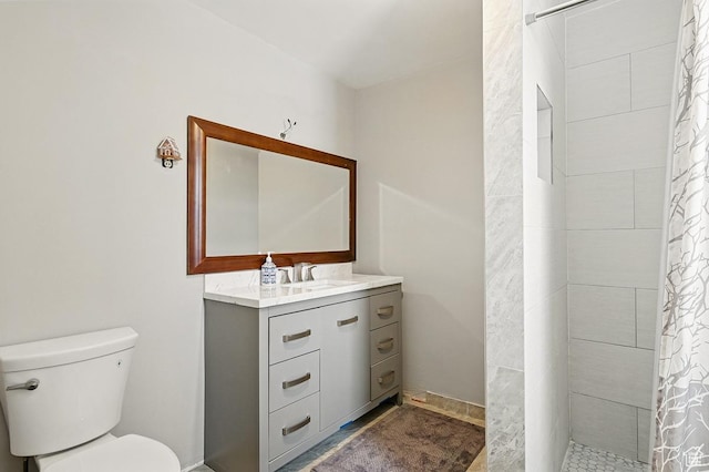 63 E Main, Bicknell, UT 84715 - bathroom with vanity, a tile shower, and toilet