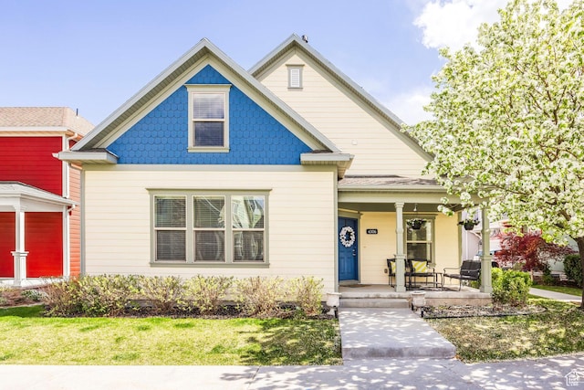 view of front of house featuring a porch and a front lawn