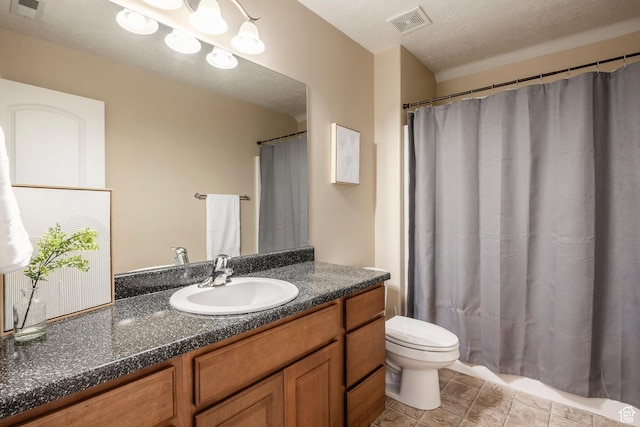 bathroom with toilet, a textured ceiling, visible vents, and vanity