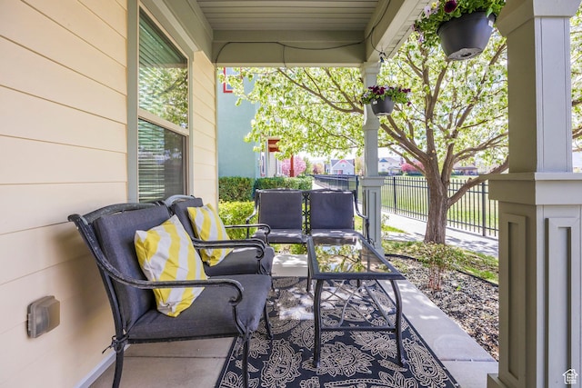 view of patio / terrace featuring an outdoor living space and fence