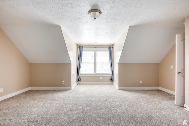 bonus room featuring carpet floors, a textured ceiling, and lofted ceiling