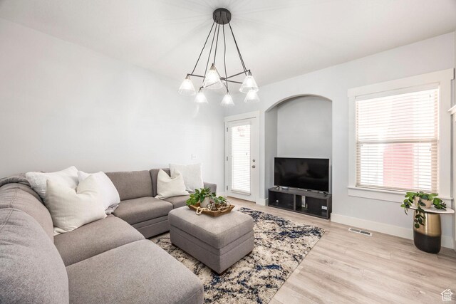 4306 Degray Dr, South Jordan, UT 84095 - living area with wood finished floors, healthy amount of natural light, and baseboards