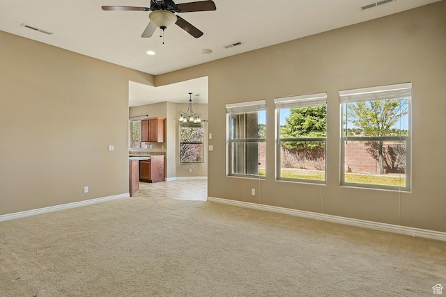 194 S 2875 W, Cedar City, UT 84720 - unfurnished living room with light colored carpet, baseboards, ceiling fan with notable chandelier, and visible vents