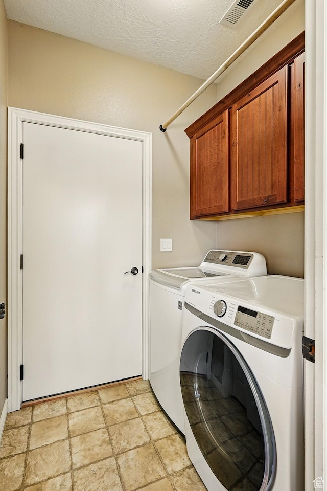 194 S 2875 W, Cedar City, UT 84720 - laundry area with visible vents, washer and clothes dryer, cabinet space, and stone finish flooring