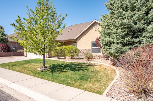 194 S 2875 W, Cedar City, UT 84720 - view of property hidden behind natural elements with a front lawn, stone siding, a garage, stucco siding, and concrete driveway