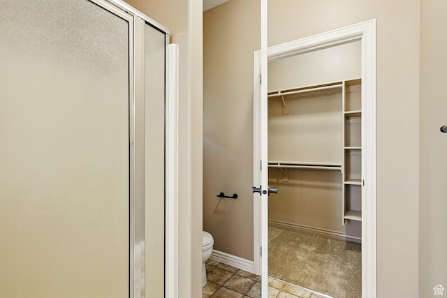 194 S 2875 W, Cedar City, UT 84720 - bathroom with toilet, baseboards, a spacious closet, and a stall shower
