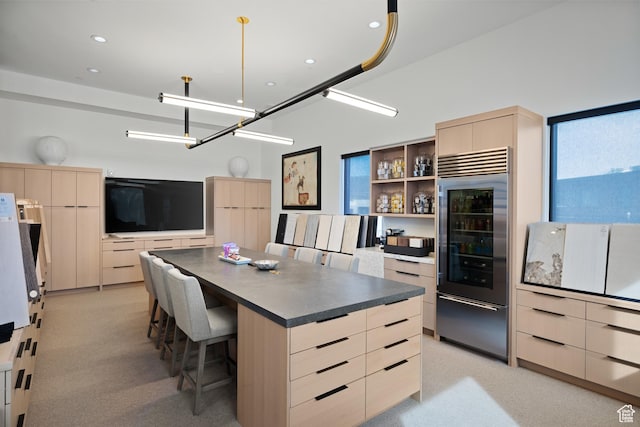 4554 N Forestdale Dr Unit A1, Park City, UT 84098 - kitchen with light brown cabinets, dark countertops, modern cabinets, a kitchen breakfast bar, and stainless steel built in fridge