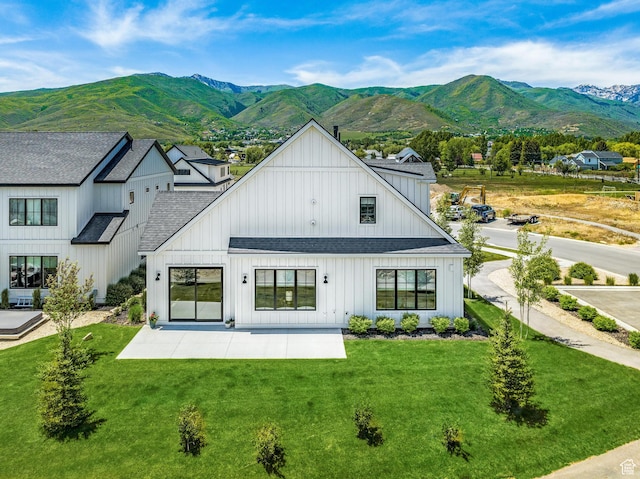 522 N Farmhouse Way, Midway, UT 84049 - rear view of property with a lawn, a patio, a shingled roof, and a mountain view