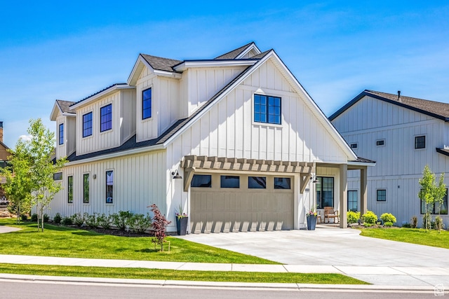 modern farmhouse style home with a front lawn, a shingled roof, board and batten siding, an attached garage, and driveway