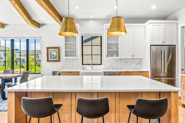 522 N Farmhouse Way, Midway, UT 84049 - kitchen featuring a sink, light countertops, stainless steel appliances, decorative backsplash, and glass insert cabinets