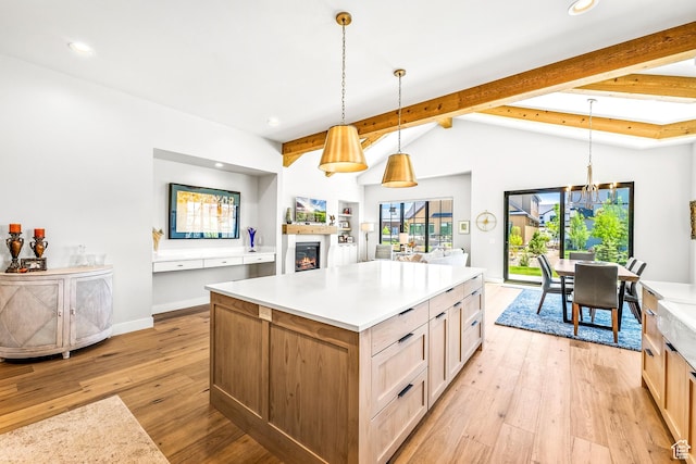 522 N Farmhouse Way, Midway, UT 84049 - kitchen featuring light countertops, light wood-style flooring, recessed lighting, vaulted ceiling with beams, and a lit fireplace